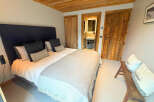 This cozy bedroom features a comfortable bed with plush pillows and a stylish headboard.