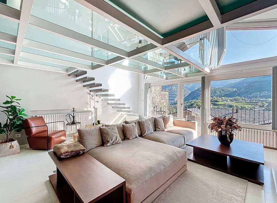 Experience luxury living in this stunning property featuring a unique glass ceiling and a modern staircase.