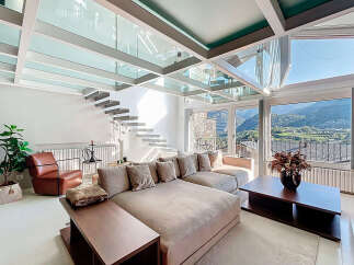 Experience luxury living in this stunning property featuring a unique glass ceiling and a modern staircase.