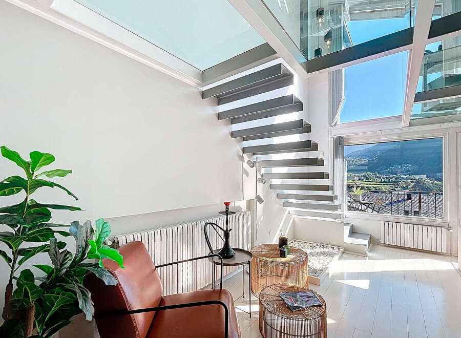 Discover a modern oasis with this stunning property, featuring a unique floating staircase and expansive windows that flood the space with natural light.