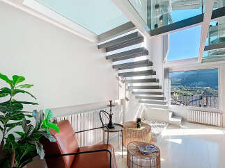 Discover a modern oasis with this stunning property, featuring a unique floating staircase and expansive windows that flood the space with natural light.