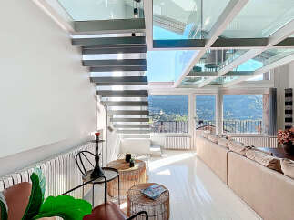 Experience luxury living in this stunning property featuring a modern glass ceiling and sleek staircase.