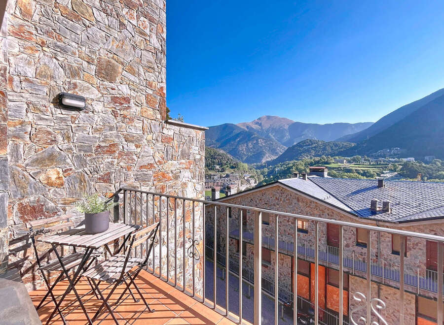 Enjoy breathtaking mountain views from this charming balcony.