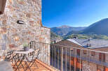 Enjoy breathtaking mountain views from this charming balcony.