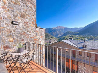 Enjoy breathtaking mountain views from this charming balcony.