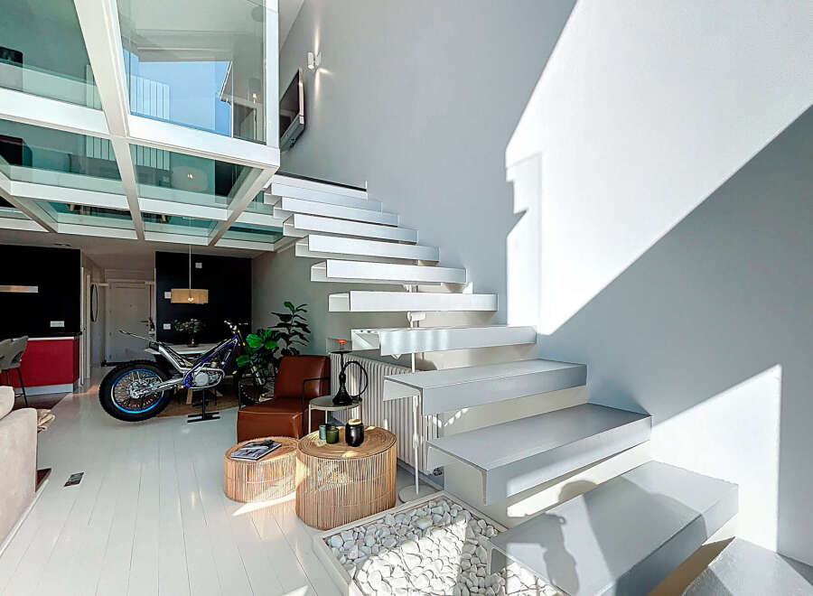 This stunning property boasts a modern design with a unique floating staircase and an abundance of natural light.