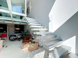 This stunning property boasts a modern design with a unique floating staircase and an abundance of natural light.