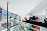 Experience luxury living in this stunning modern loft with a unique glass floor design.