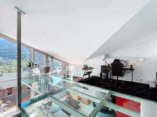Experience luxury living in this stunning modern loft with a unique glass floor design.