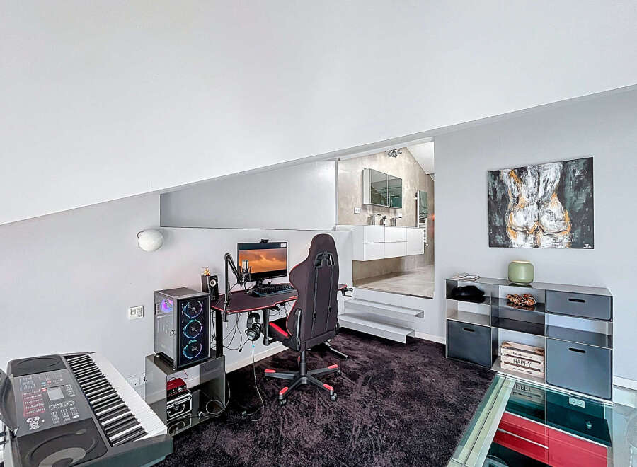 Discover modern living in this stylish property, featuring a dedicated gaming setup perfect for entertainment.