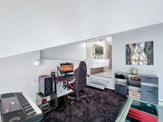 Discover modern living in this stylish property, featuring a dedicated gaming setup perfect for entertainment.