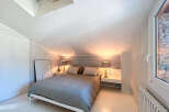 Discover the charm of this cozy bedroom, featuring a comfortable bed and stylish bedside lamps.
