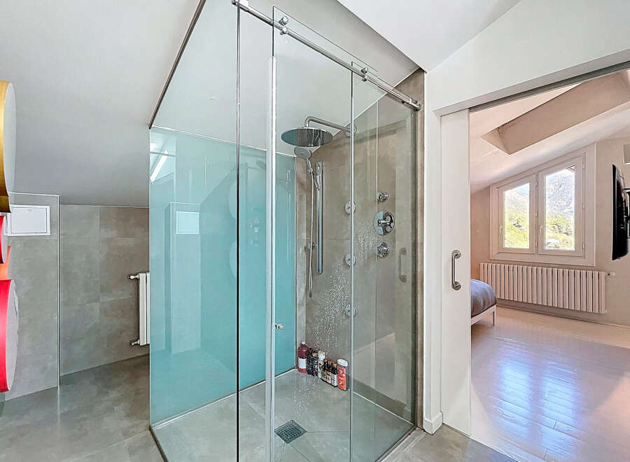 Step into luxury with this stunning bathroom featuring a modern glass shower enclosure.