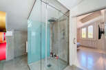 Step into luxury with this stunning bathroom featuring a modern glass shower enclosure.