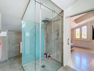 Step into luxury with this stunning bathroom featuring a modern glass shower enclosure.