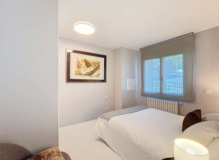 Discover this cozy bedroom featuring a comfortable bed and a stylish artwork.
