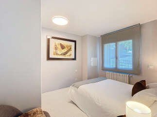 Discover this cozy bedroom featuring a comfortable bed and a stylish artwork.