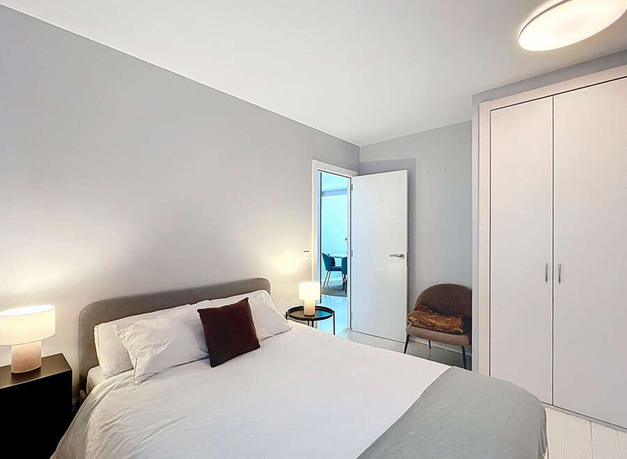 This modern bedroom offers a serene retreat with its minimalist design and neutral color palette.