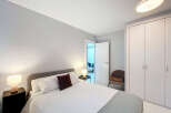 This modern bedroom offers a serene retreat with its minimalist design and neutral color palette.