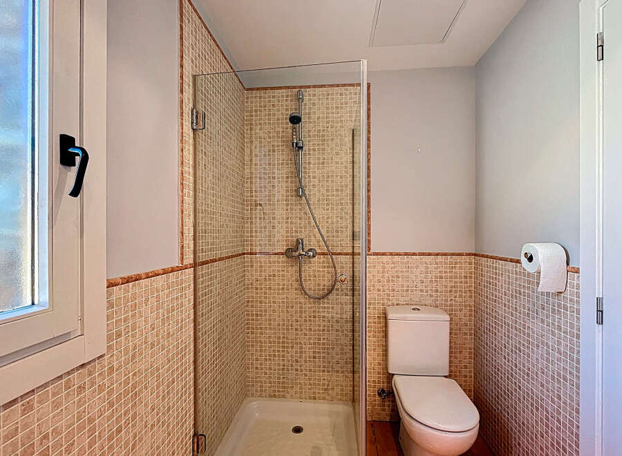Step into this inviting bathroom featuring a modern shower enclosure and stylish tile work.