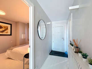 Step into this beautifully designed property featuring a modern hallway with a stylish mirror and a bright, inviting atmosphere.