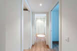 Discover the elegance of this modern hallway, featuring sleek white walls and doors that create a bright and airy atmosphere.