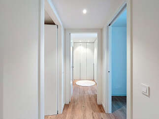 Discover the elegance of this modern hallway, featuring sleek white walls and doors that create a bright and airy atmosphere.
