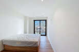Discover the serenity of this modern bedroom, bathed in natural light and offering stunning mountain views.