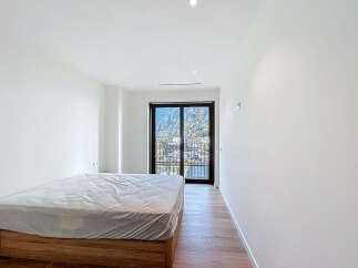 Discover the serenity of this modern bedroom, bathed in natural light and offering stunning mountain views.