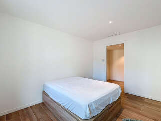 This modern bedroom offers a serene retreat with its minimalist design and neutral color palette.