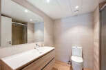Step into this modern bathroom, featuring a sleek vanity with ample storage and a pristine white countertop.