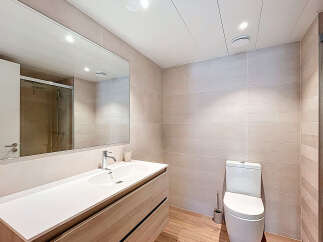 Step into this modern bathroom, featuring a sleek vanity with ample storage and a pristine white countertop.
