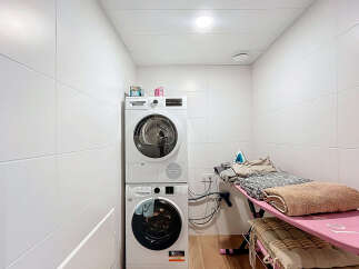 This laundry room offers a functional and organized space for all your washing and ironing needs.