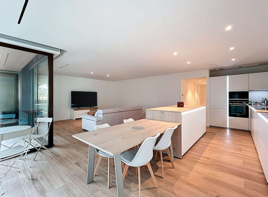 This modern apartment boasts a bright and airy open-plan living space, perfect for entertaining.