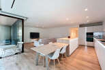 This modern apartment boasts a bright and airy open-plan living space, perfect for entertaining.