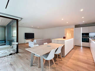 This modern apartment boasts a bright and airy open-plan living space, perfect for entertaining.