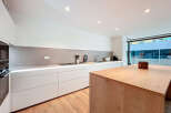 This modern kitchen boasts sleek, minimalist design with clean lines and ample storage.