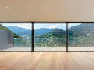 Experience breathtaking mountain views from this stunning modern home, featuring expansive floor-to-ceiling windows that seamlessly blend indoor and outdoor living.