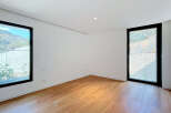 Experience modern living in this bright and airy room featuring a sleek design and abundant natural light.