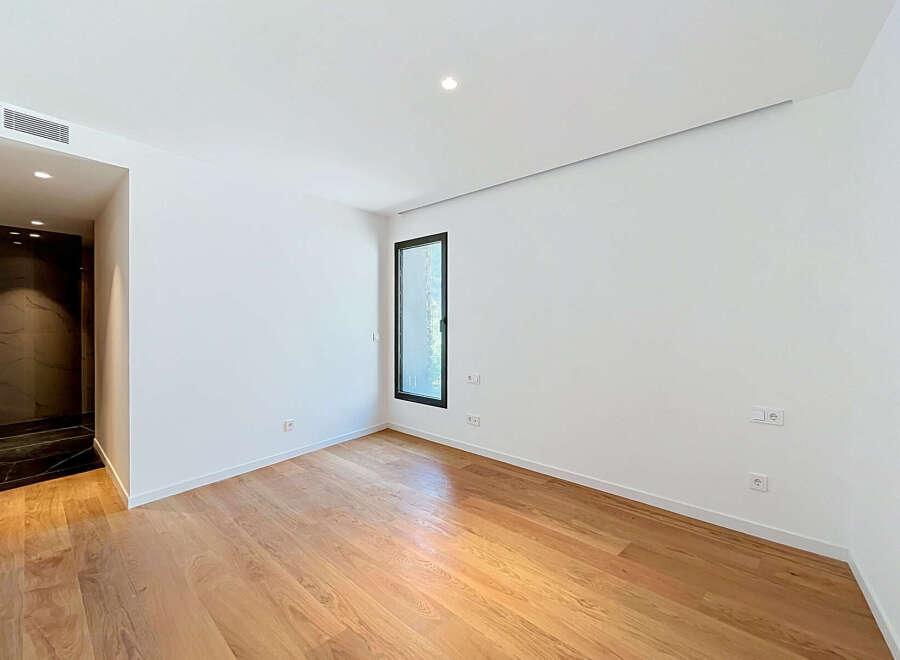 Experience modern living in this unfurnished room featuring a sleek design and ample natural light.