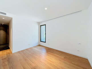 Experience modern living in this unfurnished room featuring a sleek design and ample natural light.