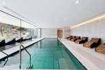 Experience ultimate relaxation in this luxurious indoor swimming pool area, featuring a stunning lap pool with crystal-clear water and integrated spa jets.