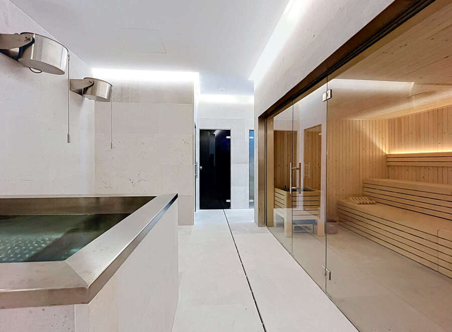 Experience ultimate relaxation in this luxurious spa area, featuring a modern plunge pool and a beautifully crafted wooden sauna.