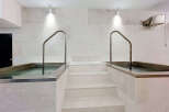 Experience ultimate relaxation in this spa-like bathroom featuring two built-in soaking tubs, perfect for unwinding.