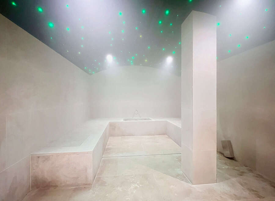 Experience ultimate relaxation in this luxurious spa-like bathroom, featuring a built-in soaking tub and ambient starry ceiling lights.
