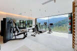Experience ultimate wellness in this state-of-the-art home gym, featuring top-tier Technogym equipment and breathtaking mountain views.