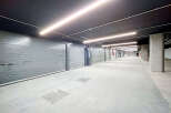 Discover this modern and secure underground parking garage, featuring individual roll-up doors for each unit.