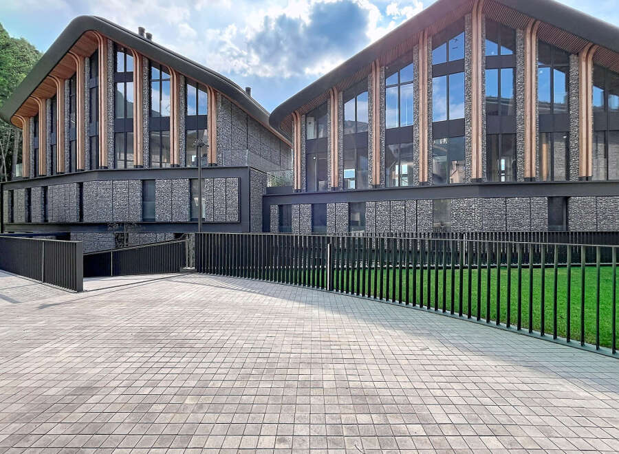 Discover modern architectural brilliance with this stunning property, featuring a unique gabion stone facade and expansive glass windows that invite natural light.