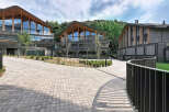 Discover modern architectural brilliance with these stunning multi-level buildings featuring unique, curved wooden-beamed roofs and expansive glass facades.