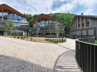 Discover modern architectural brilliance with these stunning multi-level buildings featuring unique, curved wooden-beamed roofs and expansive glass facades.